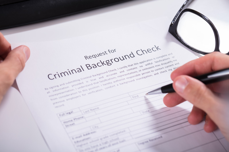 Hand Filling Criminal Background Check